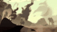 a blurry picture of a group of people standing on top of a hill .
