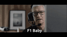 a man wearing headphones and a microphone says " f1 baby "