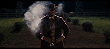 a man in a cowboy hat smoking a cigar
