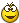 a pixelated smiley face with big eyes and a red mouth