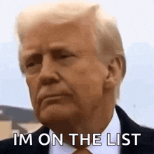 a close up of a man 's face with the words `` i 'm on the list '' written on it .