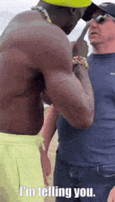 a shirtless man talking to another man with the words i 'm telling you written below him