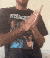 a man wearing a black t-shirt with the word vt22a73h on it