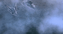 a plane is flying through a foggy sky