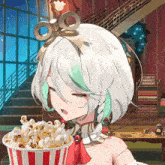 a girl with white hair and green highlights is holding a bucket of popcorn