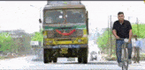 a man is riding a bike in front of a truck