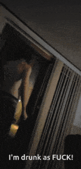 a man standing in a doorway with the words " i 'm drunk as fuck " on the bottom
