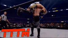 a man in a wrestling ring with the word tim on the bottom right