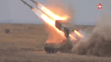 a rocket is being launched in the desert with a red star in the background