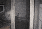 a kitchen with a microwave and a refrigerator and a light switch on the wall