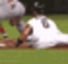 a blurry picture of a baseball game with a player wearing the number 14