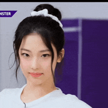a close up of a girl 's face with a purple background that says monster