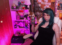 a woman with blue hair is holding a can of mtn dew