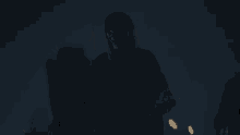 a silhouette of a person in a dark room