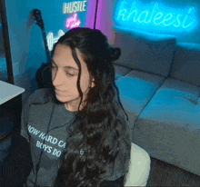 a woman wearing a t-shirt that says now hard can boys do