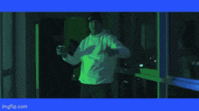 a man in a blue hoodie is reflected in a mirror with the words imgflip.com below him