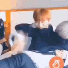 a man is laying on another man 's lap on a bed in a room .