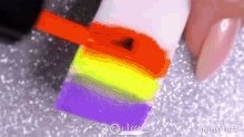 a person is applying neon nail polish to their nails .