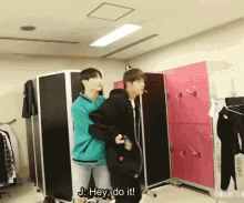 a man carrying another man in a room with the words hey do it