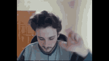 a man with a microphone in his ear is making a funny face