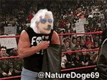a man in a wrestling ring with a dog head on his chest