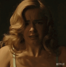 a close up of a woman 's face with netflix written on the bottom