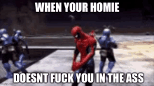 a spider-man is standing in front of a group of soldiers in a video game .