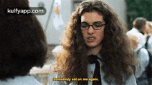 a woman wearing glasses and a tie is talking to another woman and says `` somebody sat on me again '' .