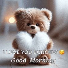 a teddy bear is holding a heart in its paws and says i love you bunches good morning