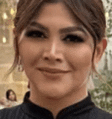 a close up of a woman 's face smiling .
