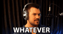 a man wearing headphones is singing into a microphone and the word whatever is on the screen