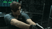 a video game character is holding a gun in front of a screen
