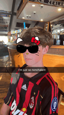 a young boy wearing sunglasses and a hello kitty face mask says i 'm just so nonchalant