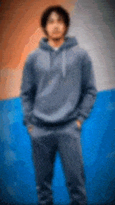a blurry picture of a man wearing a hoodie and sweatpants