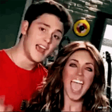 a man and a woman are posing for a picture with their mouths open