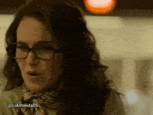a woman wearing glasses and a scarf has the username lialmeida05