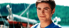 a young man is smiling in front of a boat in the water .