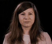 a woman with long hair making a funny face with her mouth open