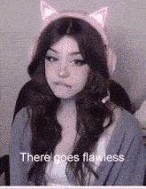 a girl wearing headphones and a cat ear headband with the words " there goes flawless " on the bottom