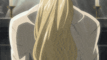 a woman with long blonde hair is standing in front of a mirror
