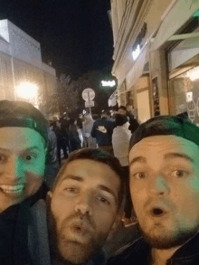 a group of men are posing for a picture in front of a store that says subway
