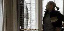 a woman is standing in front of a window with blinds and says and i thought it was tomorrow .