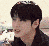 a close up of a man 's face with # 1 hater written on his forehead