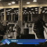 tekken 7 is displayed on a screen in a blurry photo