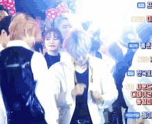 a group of people are dancing in front of a screen with chinese writing