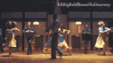 a group of people are dancing in an office with #abigbold beautifuljourney written on the bottom