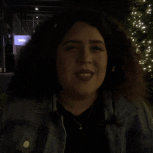 a woman in a denim jacket says would