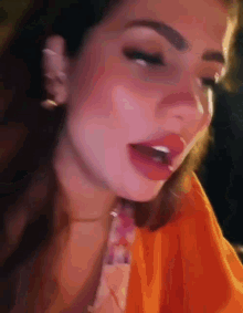 a close up of a woman 's face with a red lip
