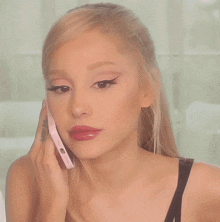 a woman with a tattoo on her arm is talking on a phone