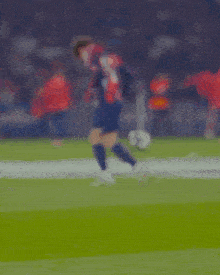 a soccer player wearing a nike jersey stands on the field looking up